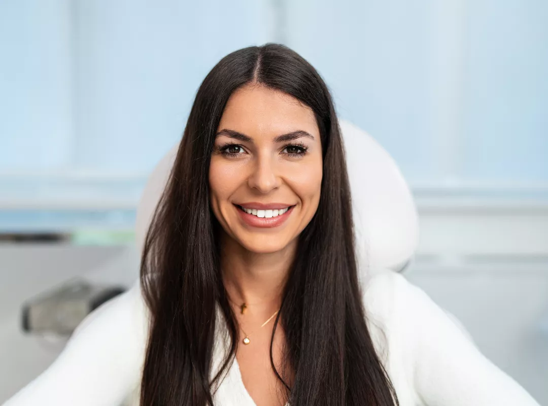 Happy woman in medspa Outsourcing your front desk to SalesMD is not about replacing staff